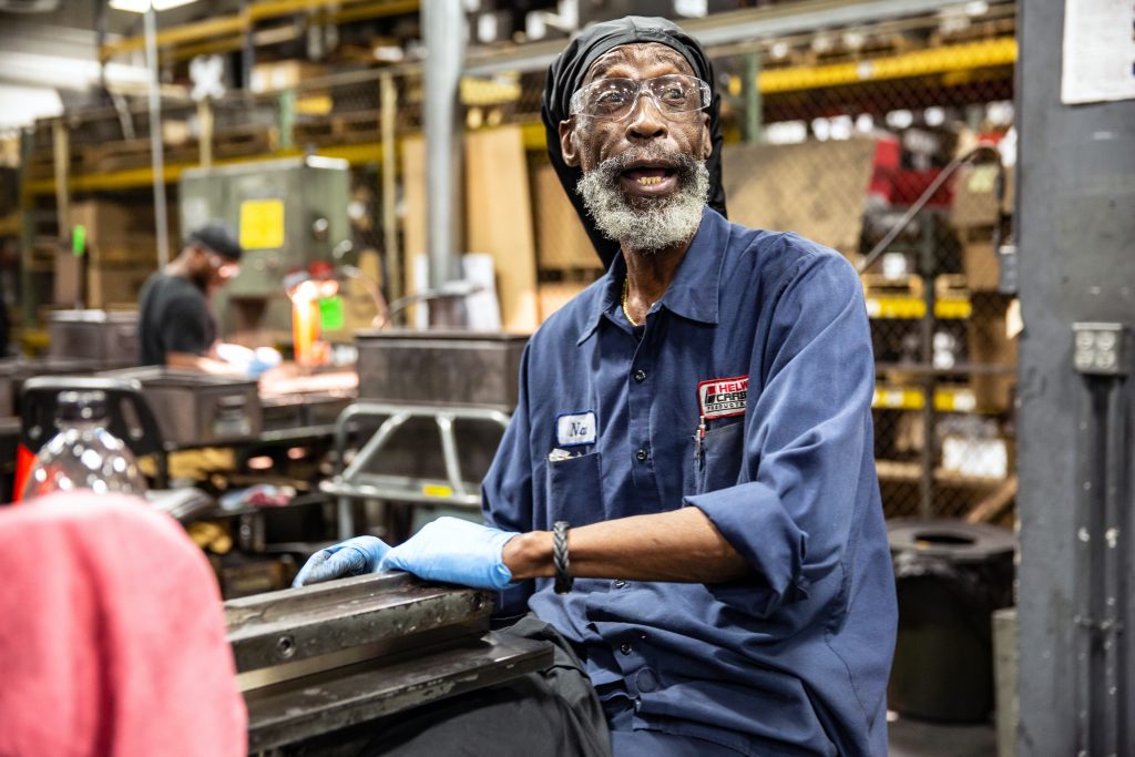 Copyrighted 2018 Ken Cooper. An older man works in the factory at Helwig Carbon.