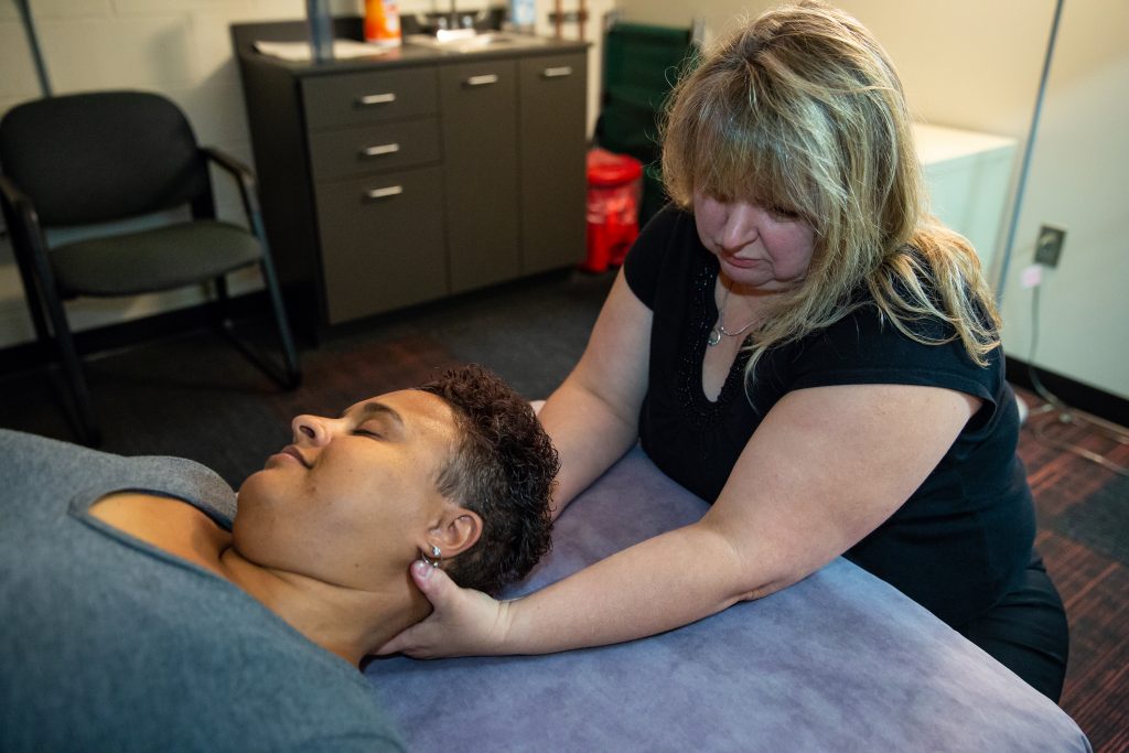 Copyrighted 2018 Ken Cooper. An employee at Helwig Carbon receives a neck massage from an on-site massage therapist
