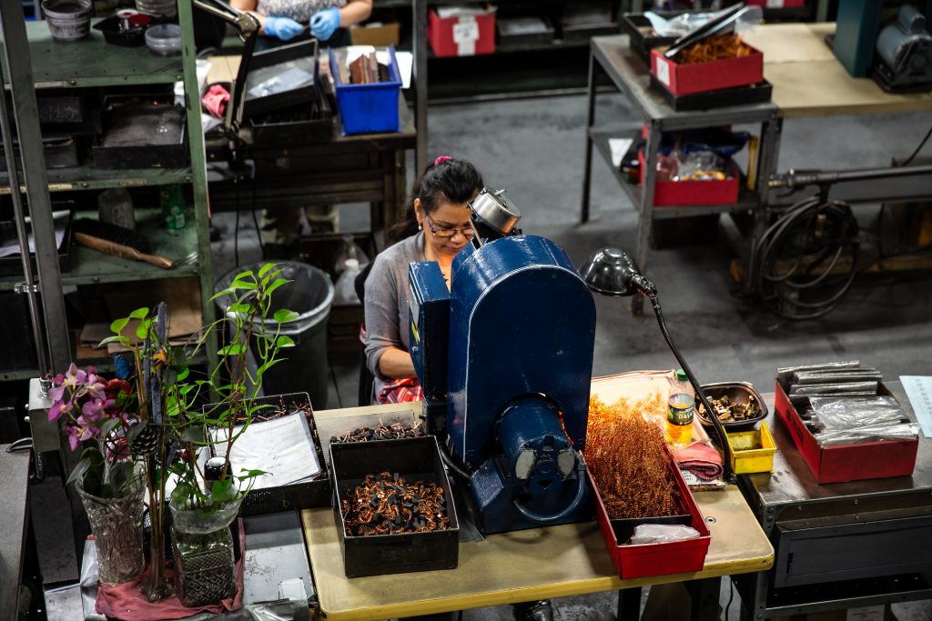 Copyrighted 2018 Ken Cooper. Overhead view of a woman at work in the factory at Helwig Carbon